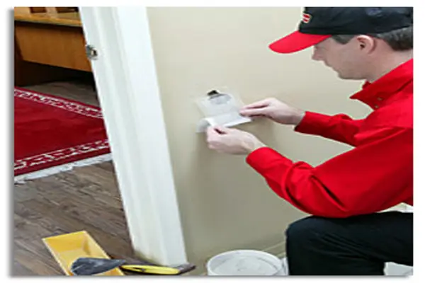 Handyman repairing drywall hole in Cincinnati home