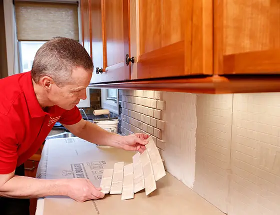 handyman installing kitchen backsplash