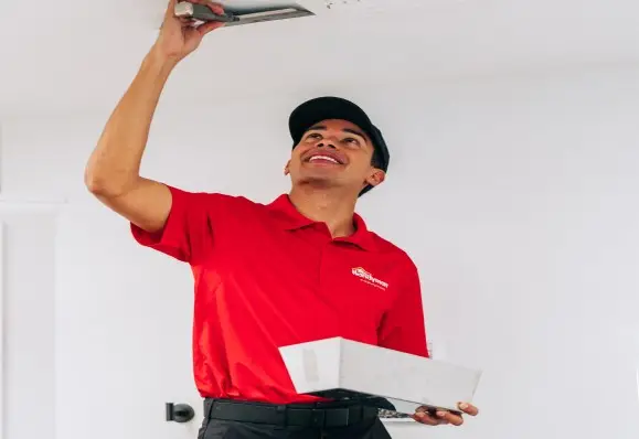 Mr. Handyman technician performing drywall ceiling repair.