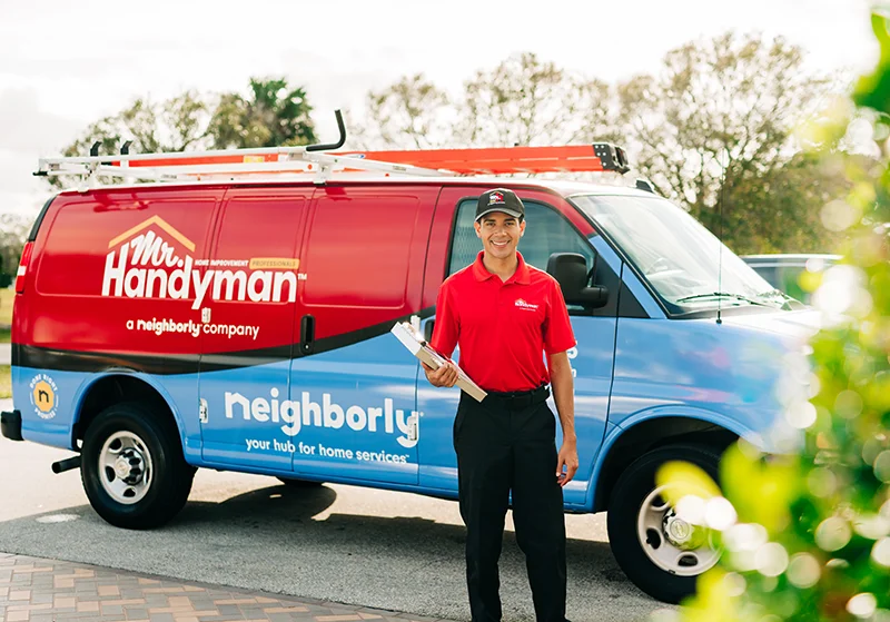 Mr. Handyman tech in front of work van before home repair service 