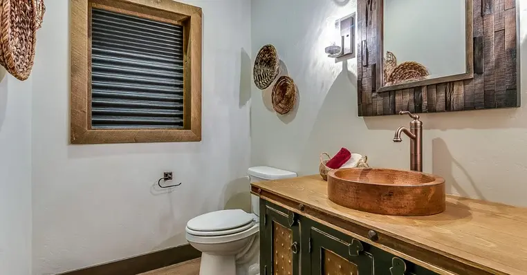 A newly completed bathroom remodel in Keller, TX with a rustic design that utilizes many wooden elements.