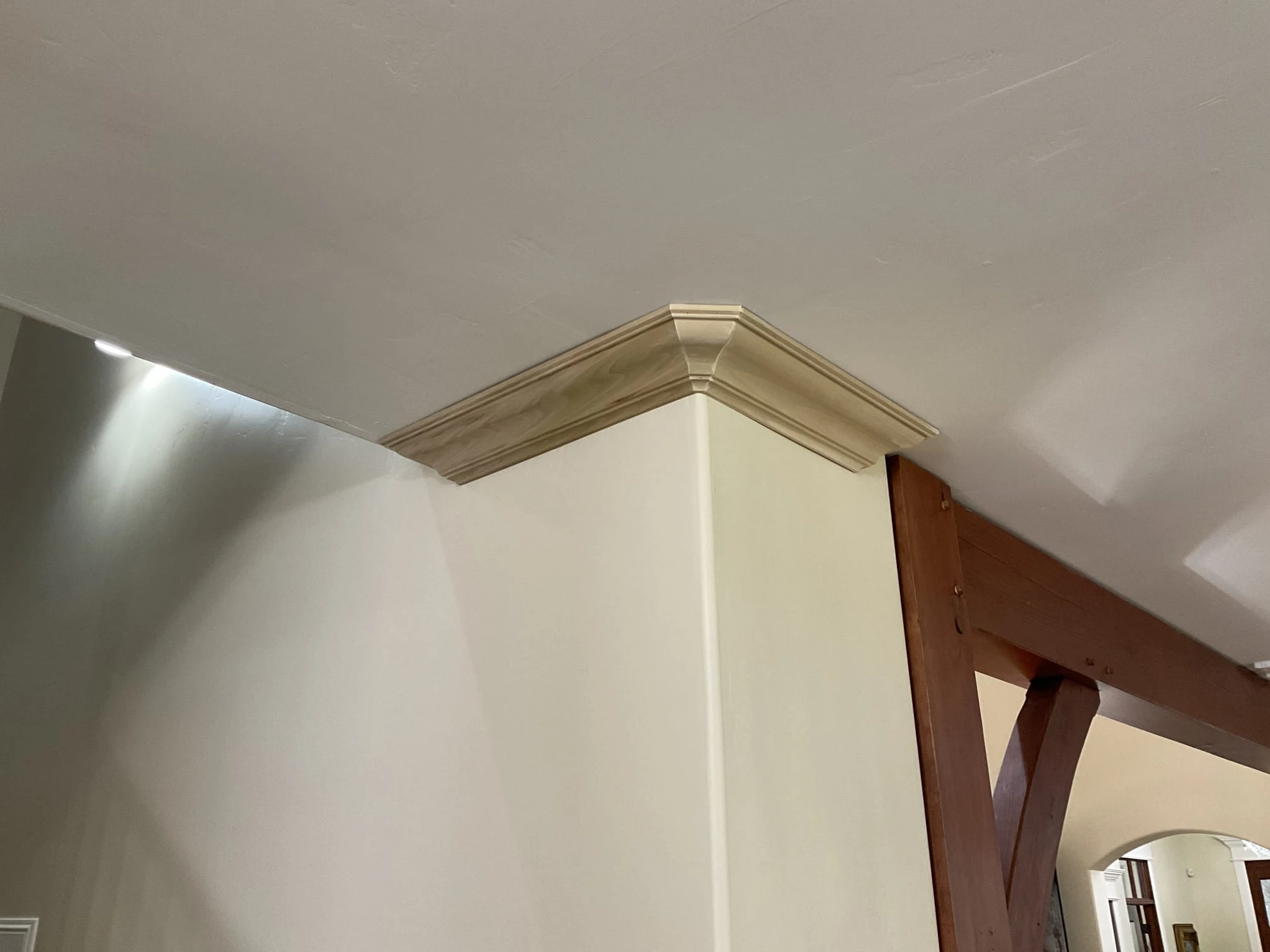 New crown molding on the top corner of a wall in a home that has received professional installation services for finish carpentry in Lehi, UT.