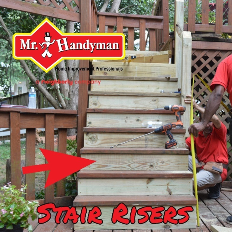 Two handymen in the process of replacing stair risers on the deck stairs outside of a home during an appointment for stair repairs in Northern Virginia.