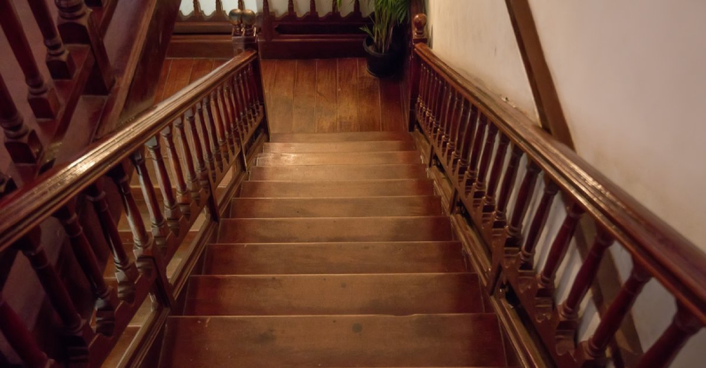 A set of dark wooden stairs inside of a home that have been kept in good condition with professional services for stair repair in Northern Virginia