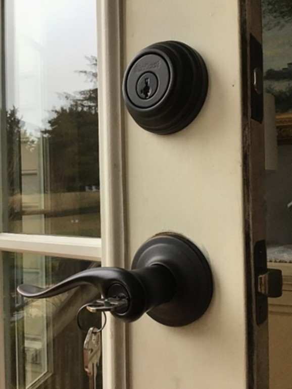 A close-up of a newly installed door handle that has been installed on the exterior of a home as part of an aging in place modification project.