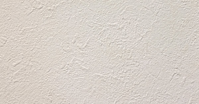 A close-up of a textured drywall surface that has been added to a home with professionals services for texturing in Frisco, TX.
