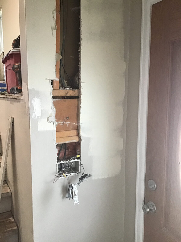 A large vertical hole in the wall of a home in Boulder, CO before it has been patched and fixed by Mr. Handyman.