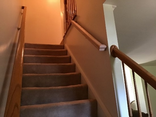 An interior staircase with handrails that have been installed on both sides of the stairs to increase accessibility for aging in place.