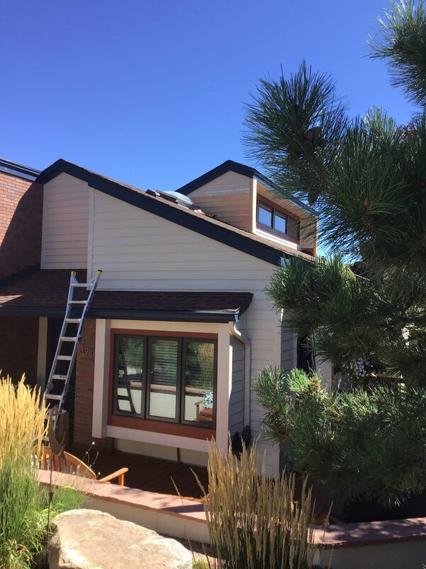 Boulder home in the process of receiving gutter cleaning by Mr. Handyman.