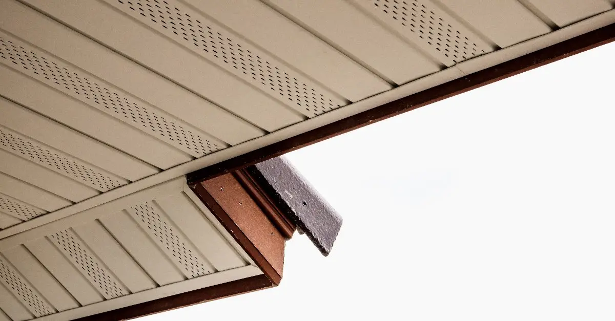 The underside of a residential roof, where soffit boards with vents are visible running toward the roofline.