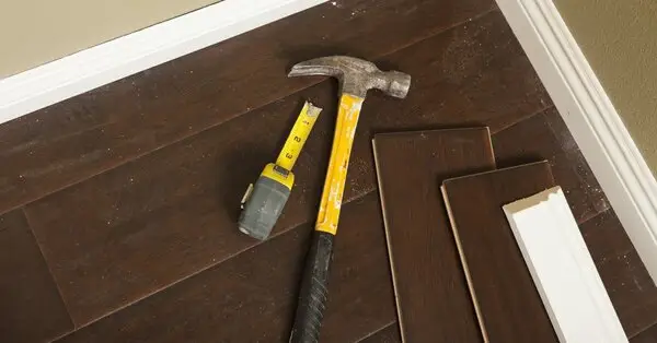 Set of tools used during flooring installation in Colorado Springs alongside extra material