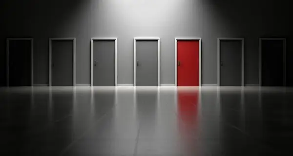 A row of interior doors with a single red door marked for interior door repair in Dallas, TX.