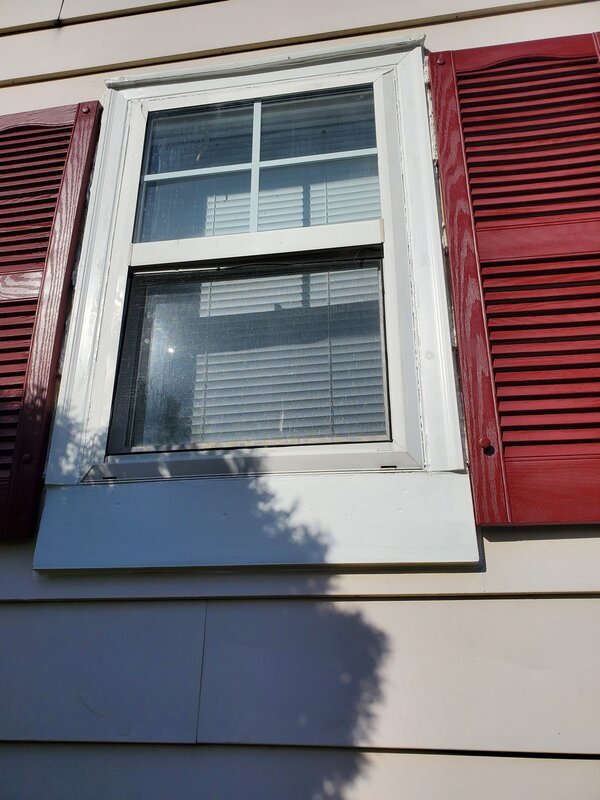  Newly repaired window on Fairfax home by Mr. Handyman