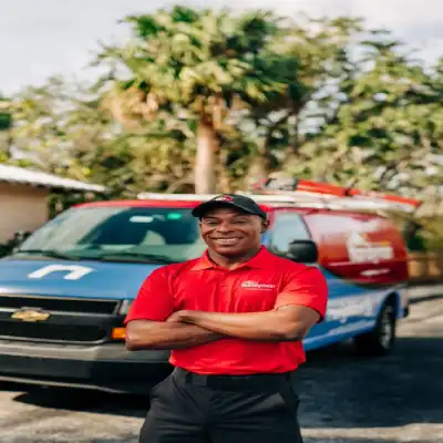 A smiling Handyman in front of a van