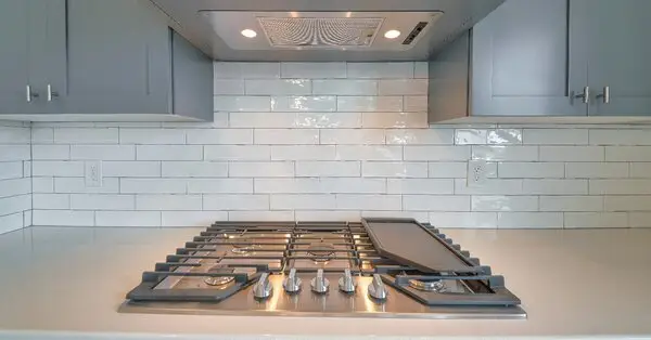 A new kitchen backsplash made of white subway tile installed using professional services for backsplash installation in Wichita, KS.