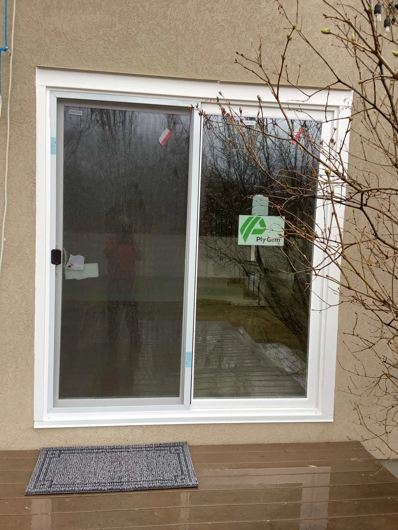 A white door frame around a newly installed sliding glass door in a home that has received professional services for door installation and finish carpentry in Lehi, UT.