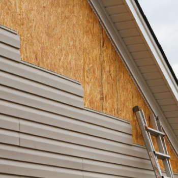 A house with siding being installed.