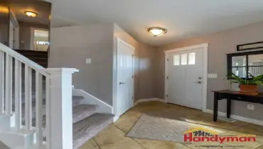 Mr. Handyman technician installing built-in mudroom bench and storage in a Plano, Texas home.