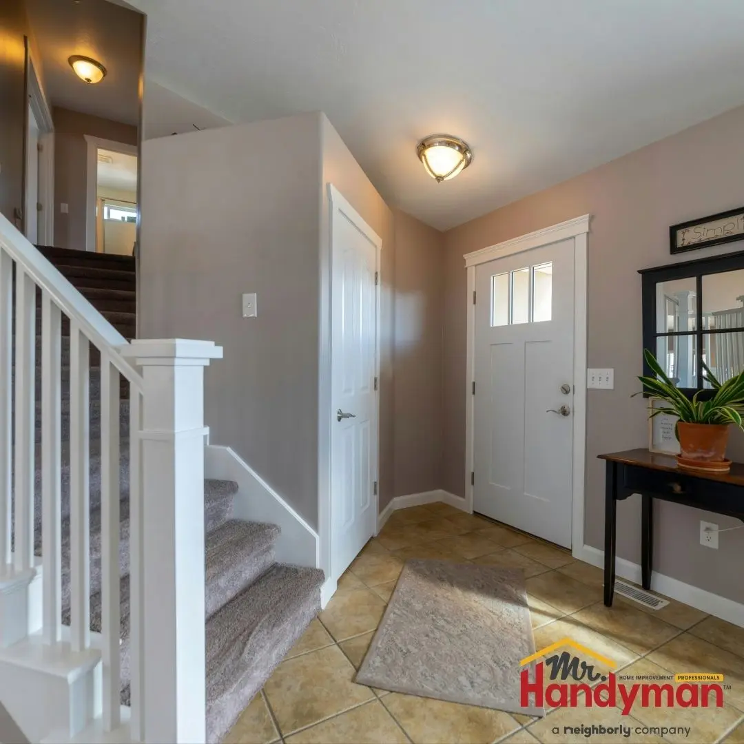 Mr. Handyman technician installing built-in mudroom bench and storage in a Plano, Texas home.