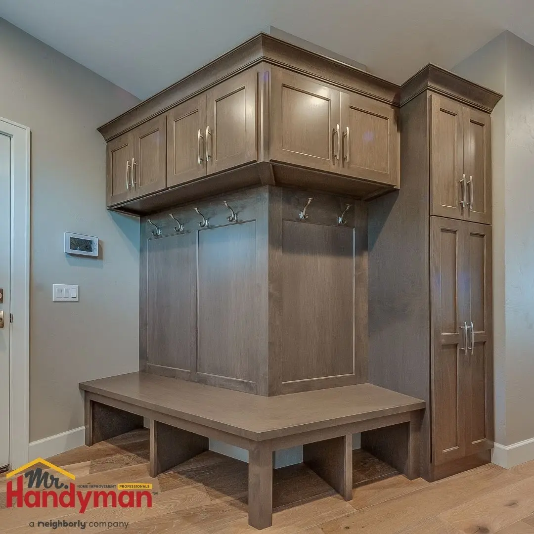 Mr. Handyman technician installing built-in mudroom bench and storage in a Plano, Texas home.
