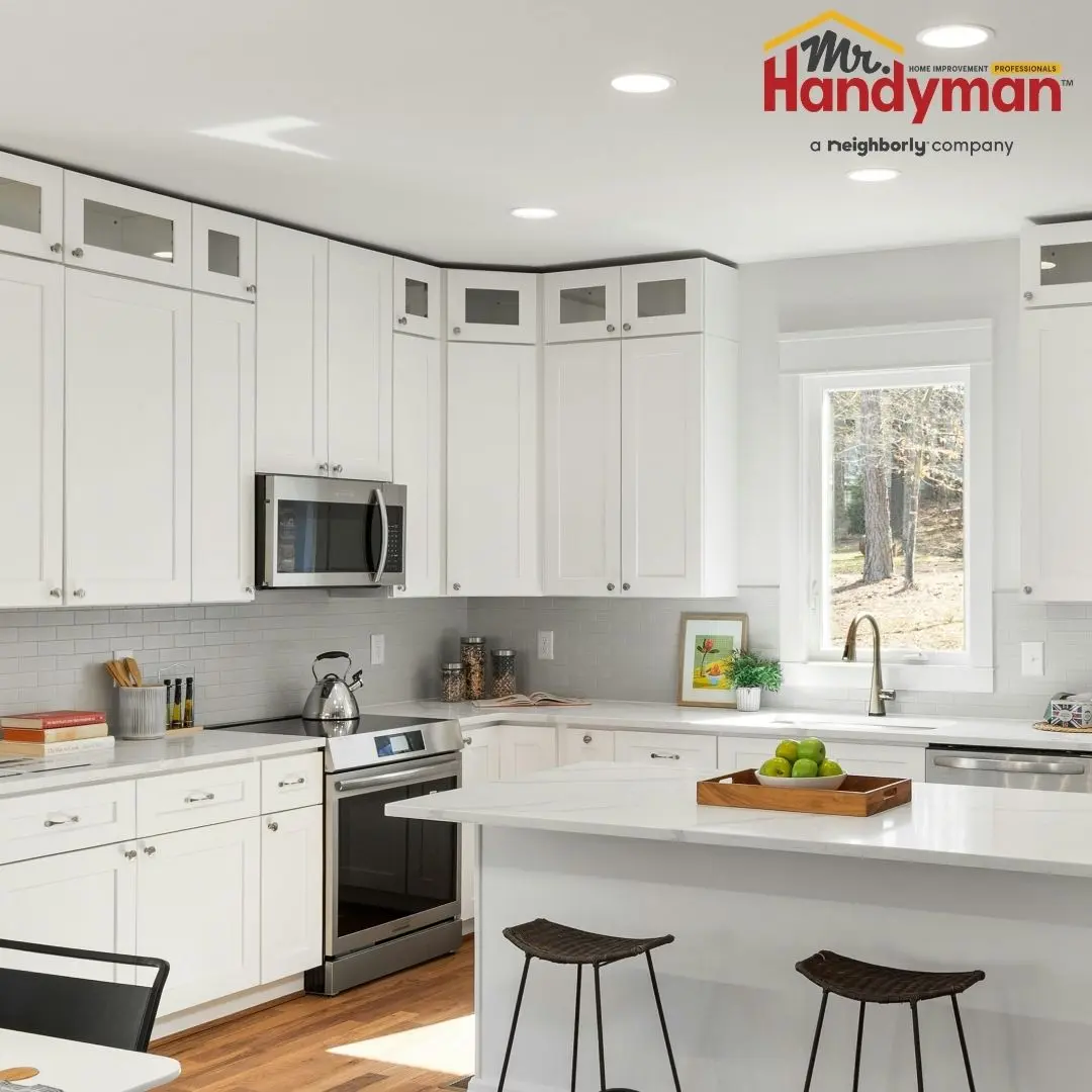 Mr. Handyman technician installing kitchen island cabinetry in a Plano, Texas home ahead of summer entertaining season.