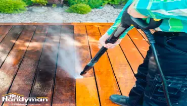 Handyman installing deck lighting for summer outdoor entertaining at a home in Ann Arbor Michigan