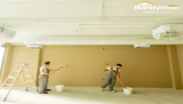 Handyman restoring a commercial entry floor and door hardware in Ann Arbor Michigan