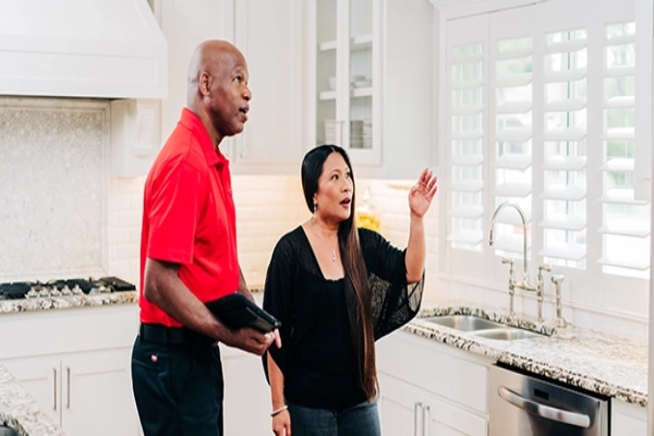 Mr. Handyman handrail installation professional meets with a homeowner.