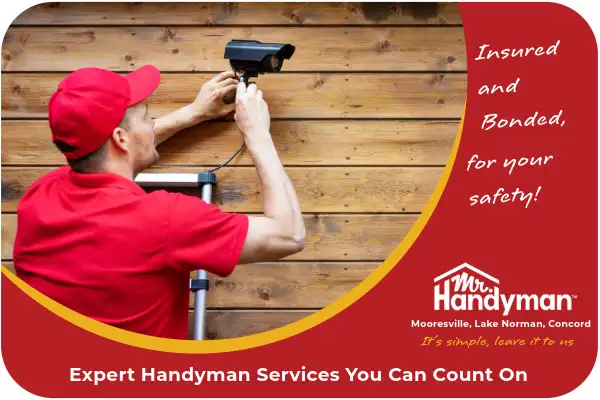 Handyman installing security camera.