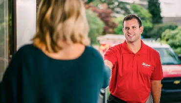 Mr. Handyman greeting customer.