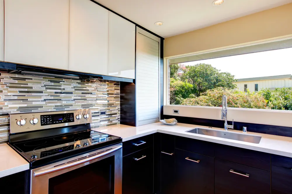 kitchen stove with tile backsplash