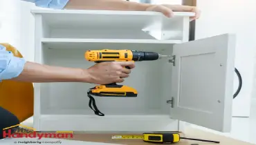 Mr. Handyman technician installing coordinated cabinet hardware and caulking trim joints in a Martinsburg, West Virginia home remodel