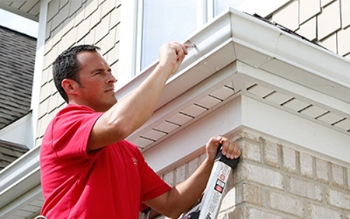 Mr. Handyman repairman inspecting a home.