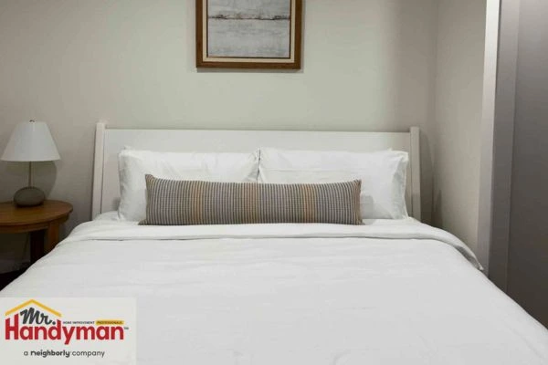 Home theater setup in finished basement with seating and screen installed by Mr. Handyman