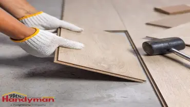 Mr. Handyman technician installing luxury vinyl plank flooring in a Dallas, Texas home