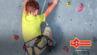 Child climbing a rock wall.