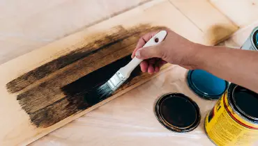 Painting a wooden panel. 
