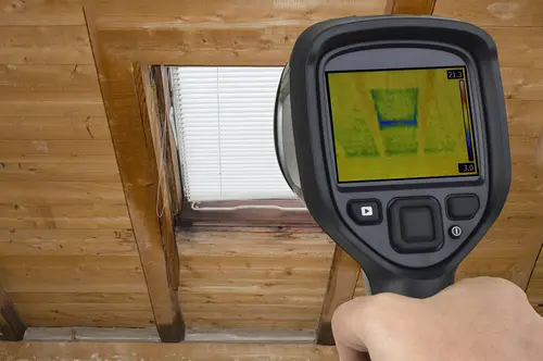 Infrared thermal scan showing heat loss through attic window.