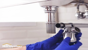 Mr. Handyman technician servicing locker room plumbing fixtures at a South Bend Northern Indiana fitness facility.