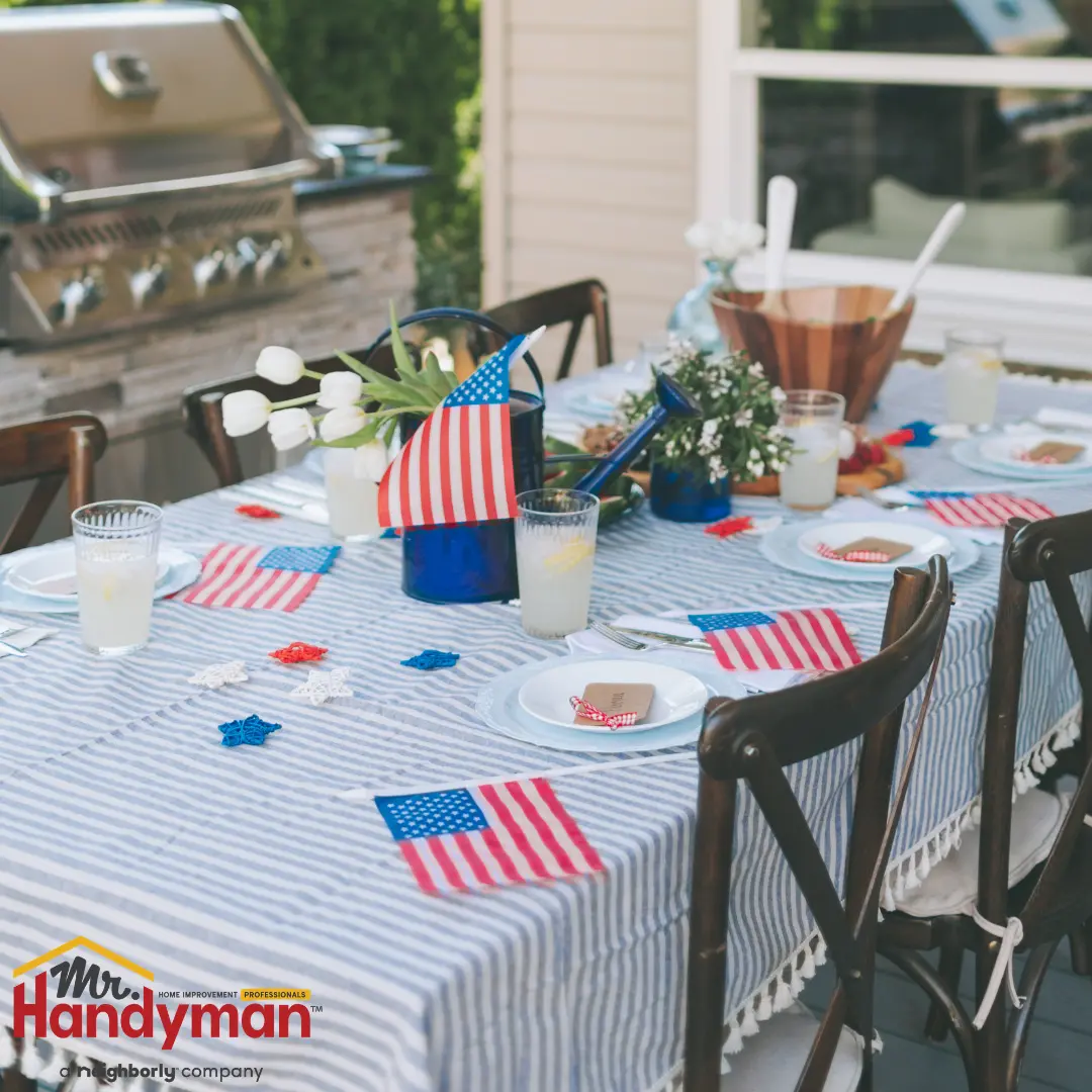 Table setting with patriotic red, white, and blue decorations, including an American flag centerpiece.