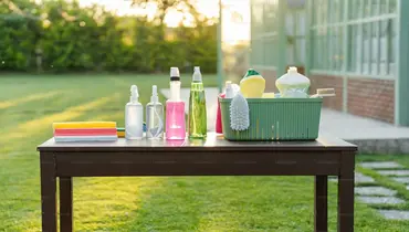 Cleaning supplies are set out on a table.
