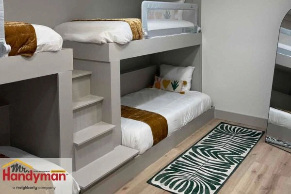 Home theater setup in finished basement with seating and screen installed by Mr. Handyman