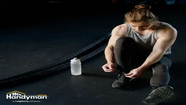 Mr. Handyman technician inspecting and repairing commercial gym flooring at a Murfreesboro fitness facility.