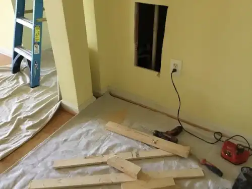 A drywall repair project in progress, with a rectangular hole in the wall and 