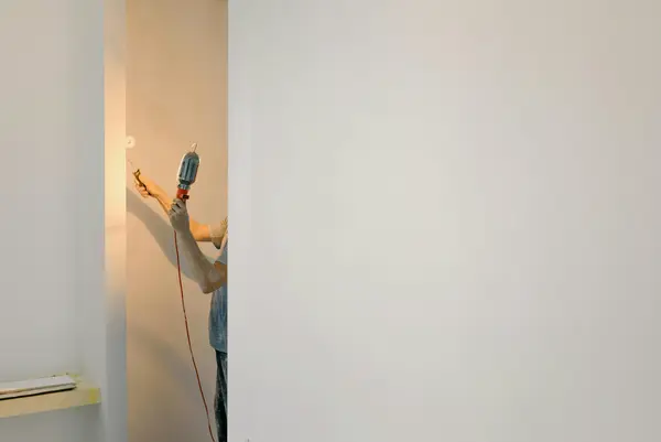 Painting walls in room.