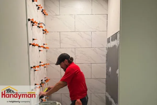Mr. Handyman professional installing shower tiles in Northern St Joseph