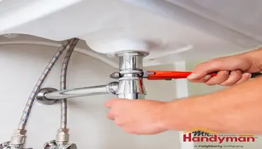 Handyman adjusting a door hinge in a Cedar Hill, TX home