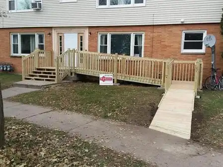 The finished wheelchair ramp and stairs outside the veteran's home.