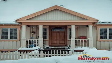 Handyman repairing exterior caulking and trim on a Greensburg, PA home in spring