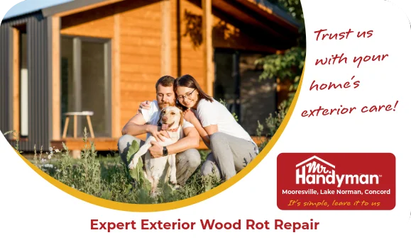 Couple sitting on lawn with dog outside wooden house.